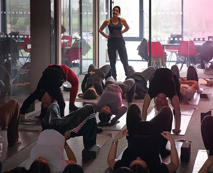 Yoga instructor at a yoga session in an office.
