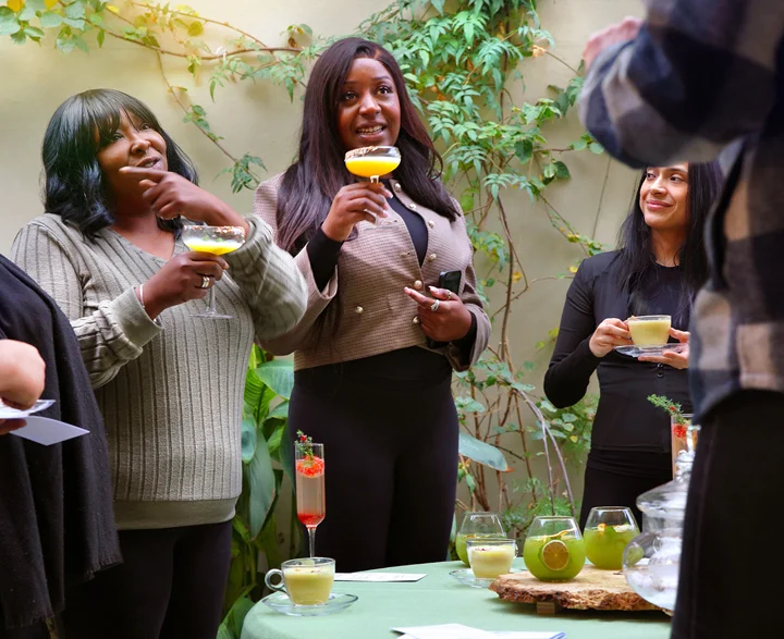 Women enjoying and smiling while drinking Free Spirit drinks.