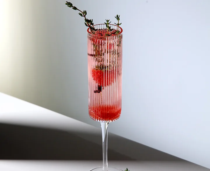 The Ether drink served in a tall, stemmed glass.