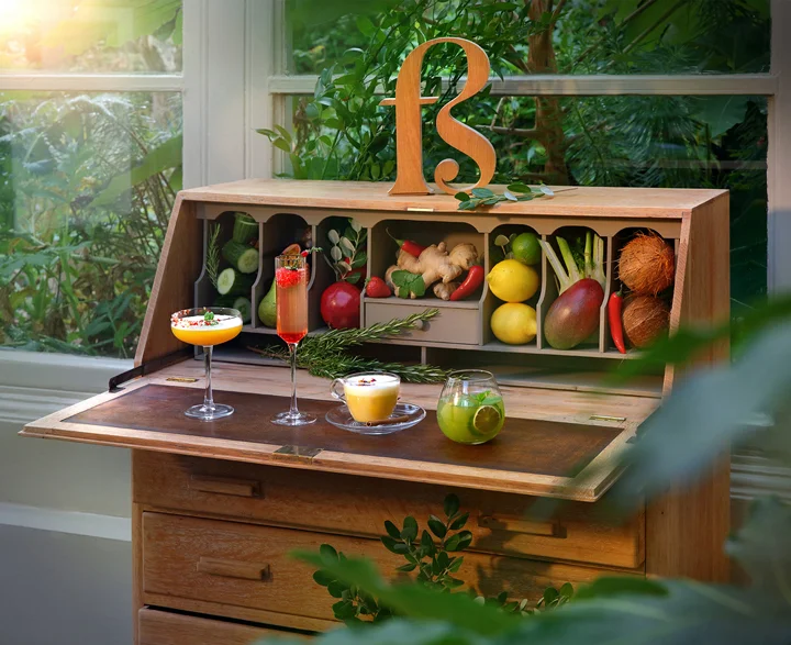 Four Free Spirit drinks — Earth, Fire, Ether and Air — served in cocktail glasses with garnishes on a board.