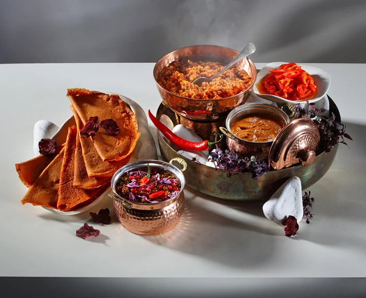 Spicy, energising dosa food served in copper pots.