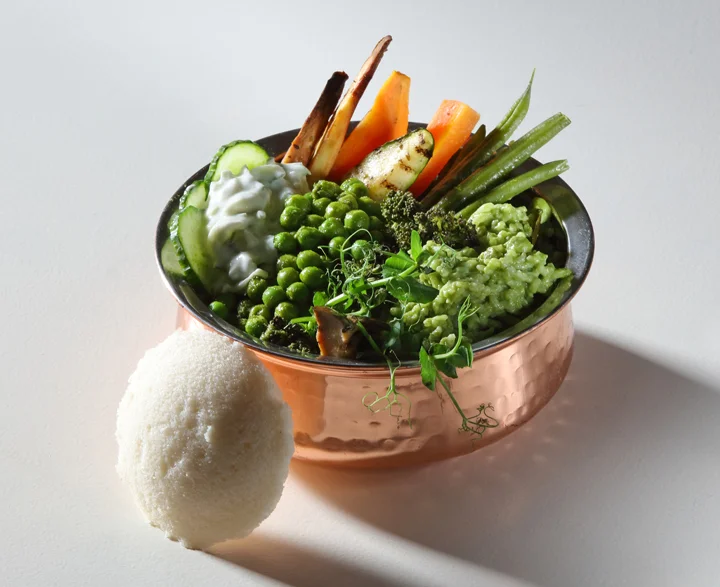 Green vegetable dosa filling served in a copper pot.