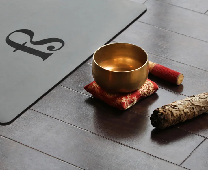 Branded Free Spirit yoga mat with sound bath bowl.